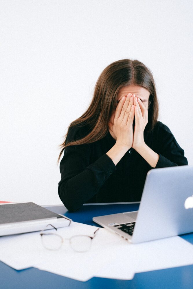 stressed out woman in front of laptop computer