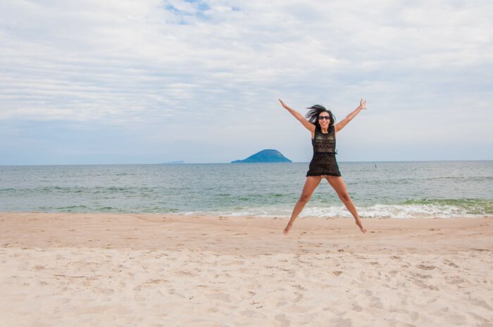 Woman doing jumping jacks (star jumps) for cardio fitness