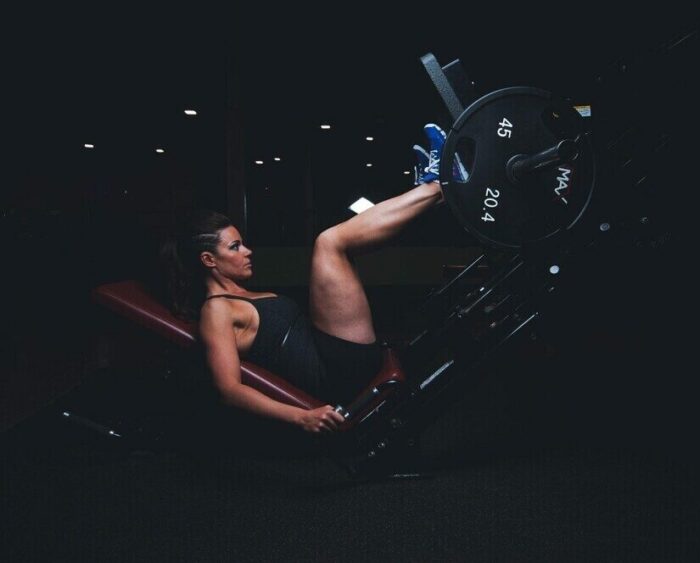 Gym workout log showing exercises, sets, reps, and weights