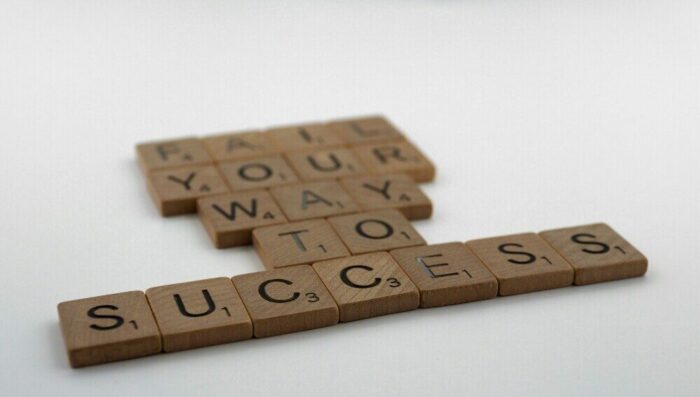 scrabble tiles spelling out fail your way to success.  In relation to overcoming setbacks