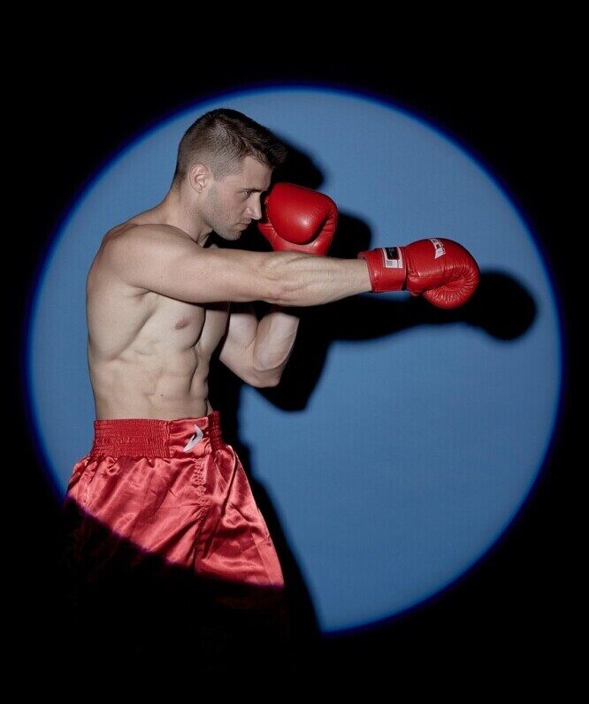 Picture of man boxing to represent trying new workouts to stay motivated at the gym