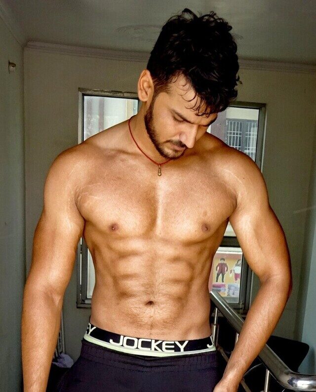 man showing off ab muscles as as a result of ab workouts for weight loss