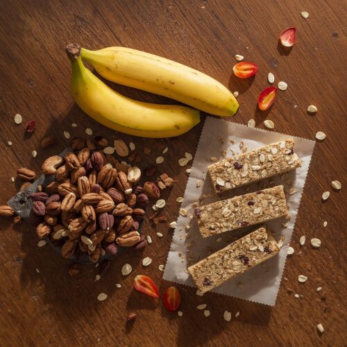 healthy travel snacks including bananas nuts and oat bars
