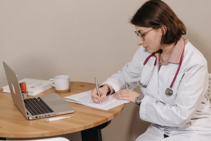 Image depicting symptoms of Crohn's disease and a doctor holding a stethoscope, representing seeking medical attention for symptoms.