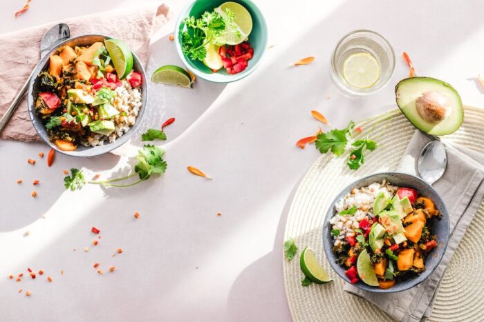 A person eating a healthy plate of food, with fruits, vegetables, and whole grains, representing dietary changes to ease IBD.